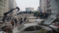 People search for survivors in Diyarbakir, Turkey, on February 6, 2023, after a 7.8-magnitude earthquake struck the country's south-east. (Photo by ILYAS AKENGIN / AFP)