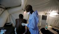 A Senegalese army doctor examines a local resident at the army field hospital, amid the outbreak of the coronavirus disease (COVID-19) in Touba, Senegal, May 1, 2020. (REUTERS/Zohra Bensemra)