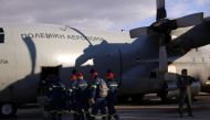 Members of the Disaster Response Special Unit who will fly to Turkey to help in the aftermath of an earthquake, board a Hellenic Air Force C-130, before departing from the military airport of Elefsina, Greece, February 6, 2023. (REUTERS/Louiza Vradi)