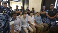 Defendants accused of the murder of Fernando Baez Sosa Ciro Pertossi (front, L), Matias Benicelli (front, 2-L), Blas Cinalli (front, 2-R), Lucas Pertossi (front, R), Ayrton Viollaz (back, L), Maximo Thomsen (back, 2-L), Enzo Comelli (back, 2-R) and Luciano Pertossi (back, R) hear their sentence at the court in Dolores, Buenos Aires province, Argentina, on February 6, 2023. (Photo by JUAN MABROMATA / AFP)