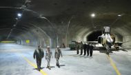 A handout picture provided by the Iranian Army office on February 7, 2023 shows Commander-in-Chief of the Iranian Army Major General Abdolrahim Mousavi (right) and Armed Forces Chief of Staff Major General Mohammad Bagheri (centre) visiting Iran's first underground military air base in an undisclosed location. (Photo by Iranian Army office / AFP) 