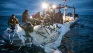 This picture provided by the US Navy shows sailors assigned to Explosive Ordnance Disposal Group 2 recover a high-altitude surveillance balloon off the coast of Myrtle Beach, South Carolina, in the Atlantic ocean on February 5, 2023.  (Photo by Petty Officer 1st Class Tyler Thompson / US NAVY / AFP)