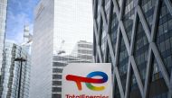 In this file photo taken on May 28, 2021 a photograph shows the new TotalEnergies logo during its unveling ceremony, at a charging station in La Defense on the outskirts of Paris. - France's TotalEnergies said Wednesday that high oil and gas prices bolstered its net profit to a record $20.5 billion in 2022. (Photo by Christophe ARCHAMBAULT / AFP)