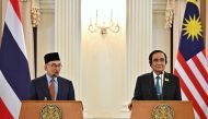 Malaysia's Prime Minister Anwar Ibrahim (L) and Thailand's Prime Minister Prayut Chan-O-Cha (R) attend a joint press conference during an official state visit at Government House in Bangkok on February 9, 2023. (Photo by Lillian SUWANRUMPHA / AFP)