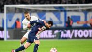 Marseille's French midfielder Valentin Rongier (left) fights for the ball with Paris Saint-Germain's Argentine forward Lionel Messi during the French Cup round of 16 football match between Olympique Marseille (OM) and Paris Saint-Germain (PSG) at Stade Velodrome in Marseille, southern France on February 8, 2023. (Photo by NICOLAS TUCAT / AFP)
