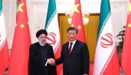 This handout picture provided by the Iranian presidency shows Chinese President Xi Jinping welcoming the Islamic Republic's President Ebrahim Raisi (L) during his visit in Beijing on February 14, 2023. (Photo by Iranian Presidency / AFP)