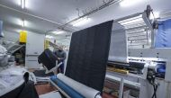 An employee works on an order of custom-made cold weather sleeping bags to be donated for earthquake relief, at the Palestinian Super-Tex al-Saafin textile factory in Hebron city in the occupied West Bank, on February 14, 2023. (Photo by HAZEM BADER / AFP)