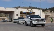Vehicles carrying the first UN delegation to visit rebel-held northwestern Syria, arrive through the Bab al-Hawa border crossing with Turkey on February 14, 2023. (Photo by Omar HAJ KADOUR / AFP)