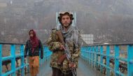 A Taliban security personnel poses for a photo along a bridge in Fayzabad district of Badakhshan province on February 13, 2023. (Photo by OMER ABRAR / AFP)