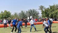 Mannai CEO and other officials taking part in a football match.