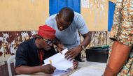 File photo: Independent National Electoral Commission (INEC) officials verify voters during a mock accreditation exercise organised by the INEC at Enitan Primary School at Surulere in Lagos, Nigeria, on February 4, 2023. (Photo by Benson Ibeabuchi / AFP)

