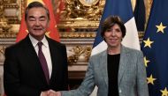 China's Foreign minister Wang Yi shakes hands with French Foreign and European Affairs Minister Catherine Colonna ahead of their meeting in Paris, on February 15, 2023. (Photo by STEPHANE DE SAKUTIN / AFP)