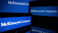 (FILES) This file photo taken on April 12, 2022 in Toulouse shows screens displaying the logo of US-based McKinsey & Company management consulting firm. - Four judicial searches perquisitions were caried out at the end of January at the home of managers and former managers of McKinsey in connection with an investigation over suspected illegal fundings in the presidential campaigns of Emmanuel Macron, according to sources close to the case on February 17, 2023. (Photo by Lionel BONAVENTURE / AFP)