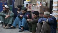 Daily wage labourers wait for work at a market in Peshawar, Pakistan, on February 17, 2023. (AP Photo/Muhammad Sajjad)