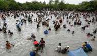 Villagers catch fish during the annual fish-catching ceremony at the Choam Krovean commune in Tboung Khmum province on February 18, 2023. (Photo by Tang Chhin Sothy / AFP)