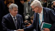 Finland's President Sauli Niinisto (left) shakes hands with Former Prime Minister of Sweden Carl Bildt at the Munich Security Conference (MSC) in Munich, southern Germany, on February 18, 2023.  (Photo by Odd ANDERSEN / AFP)