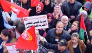 Protesters chant slogans during a demonstration called by the General Union of Tunisian Workers (UGTT) over worsening economic woes and the arrest of a top union official, in Tunisia's second city of Sfax, on February 18, 2023. (Photo by IMED HADDAD / AFP)