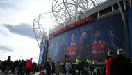 Fans pose for photos outside of Old Trafford stadium in Manchester north west England, ahead of the English Premier League football match between Manchester United and Leicester City, on February 19, 2023.  (Photo by Oli SCARFF / AFP)