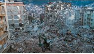 This aerial photograph taken on February 20, 2023 shows diggers removing the rubble of collapsed buildings in Antakya, southern Turkey. Photo by Sameer Al-DOUMY / AFP