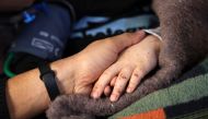 Syrian girl Sham Sheikh Mohammad, 9, who was rescued after fourty hours under the rubble of a deadly earthquake, lies on a hospital bed in the rebel-held northwestern city of Idlib, on February 17, 2023.  (Photo by Omar HAJ KADOUR / AFP)
 