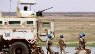 (FILES) In this file photo taken on July 24, 2019 Senegalese soldiers the UN peacekeeping mission in Mali MINUSMA (United Nations Multidimensional Integrated Stabilisation Mission in Mali) dismount an armoured personnel carrier, patrolling in the streets of Gao, a day after suicide bombers in a vehicle painted with UN markings injured one French, several Estonian troops and two Malian civilians in an attack on an international peace-keeping base in Mali. (Photo by Souleymane Ag Anara / AFP)