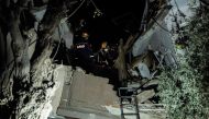 Rescue workers search for victims at a collapsed building after a 6.4-magnitude second earthquake hit the Hatay province in southern Turkey, in Antakya, on February 20, 2023, two weeks after a 7.8-magnitude one hit the first time the same region. (Photo by Sameer Al-Doumy / AFP)
