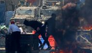 Palestinians clash with Israeli security forces during a raid in the occupied West Bank city of Nablus, on February 22, 2023. (Photo by Zain Jaafar / AFP)