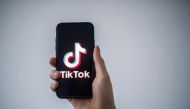 In this file photo taken on January 21, 2021 in Nantes, western France, a man shows a smartphone with the logo of Chinese social network Tik Tok. Photo by LOIC VENANCE / AFP