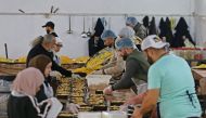Volunteers prepare food to serve people affected by the 7.8-magnitude quake, in the government-held northern city of Aleppo on February 21, 2023. (Photo by LOUAI BESHARA / AFP)