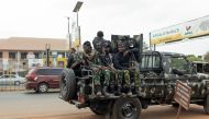 Armed Nigerian army officers sit inside a military vehicle parked outside the Central Bank of Nigeria (CBN) in Awka, Nigeria, on February 24, 2023, ahead of the Nigerian presidential elections scheduled for February 25, 2023. (Photo by Patrick Meinhardt / AFP)
 