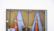 Turkish President Recep Tayyip Erdogan is seen on screen as he holds an online meeting with French President Emmanuel Macron, at the Elysee Palace in Paris on February 24, 2023. (Photo by Christophe PETIT TESSON / POOL / AFP)
