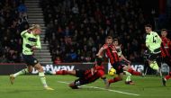 Manchester City's Norwegian striker Erling Haaland (left) has a shot on goal during the English Premier League football match between Bournemouth and Manchester City at the Vitality Stadium in Bournemouth, southern England on February 25, 2023. (Photo by ADRIAN DENNIS / AFP)