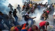Police fire tear gas to disperse activists of the opposition National People痴 Power (NPP) party during a protest held to urge the government to hold local council election as scheduled in Colombo on February 26, 2023. (Photo by ISHARA S. KODIKARA / AFP)