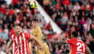Barcelona's midfielder Gavi (centre) fights for the ball with Almeria's Brazilian defender Rodrigo Ely (L) and Almeria's Spanish defender Chumi during the Spanish League match between UD Almeria and FC Barcelona at the Municipal Stadium of the Mediterranean Games in Almeria, on February 26, 2023. (Photo by JORGE GUERRERO / AFP)