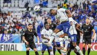 Al Hilal’s Nigerian forward Odion Ighalo (top) leaps to head the ball during the AFC Champions League semi-final against Al Duhail at Al Thumama Stadium in Doha yesterday. AFP