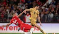 Almeria's Brazilian defender Rodrigo Ely (L) fights for the ball with Barcelona's Polish forward Robert Lewandowski during the Spanish League football match between UD Almeria and FC Barcelona at the Municipal Stadium of the Mediterranean Games in Almeria, on February 26, 2023. (Photo by JORGE GUERRERO / AFP)