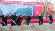 This photo taken on February 25, 2023 and released on February 26, 2023 by North Korea's official Korean Central News Agency (KCNA) shows North Korean leader Kim Jong Un (3rd R) and his daughter (3rd L) attending the ground-breaking ceremony for the construction of a new street at Sopho area of Pyongyang city. (Photo by KCNA via KNS / AFP) 