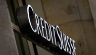 This file combination of photographs created on August 6, 2021, shows (TOP) a sign of Swiss bank Credit Suisse on a branch in Lausanne on April 6, 2021 and (BOTTOM) a sign hangs on an entrance door outside the offices of collapsed British finance firm Greensill near Warrington, north-west England, on April 12, 2021. (Photo by Oli SCARFF and Fabrice COFFRINI / AFP)