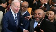 US President Joe Biden takes photos with attendees after speaking at a reception celebrating Black History Month, in the East Room of the White House in Washington, DC, on February 27, 2023. (Photo by SAUL LOEB / AFP)