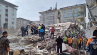 Rescuers carry on search operations among the rubble of collapsed buildings in the Yesilyurt district of Malatya on February 27, 2023 after a 5,6 magnitude earthquake hit eastern Turkiye, killing one person and wounding dozens others while causing some damaged buildings to collapse, the government's disaster agency said. (Photo by DHA (Demiroren News Agency) / AFP)
