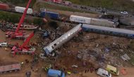 This aerial drone photograph taken on March 1, 2023, shows emergency crews examining the wreckage after a train accident in the Tempi Valley near Larissa, Greece. (Photo by STRINGER / AFP)