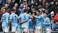 Manchester City's Portuguese midfielder Bernardo Silva (centre) celebrates with teammates after scoring their second goal during the English Premier League football match between Manchester City and Newcastle United at the Etihad Stadium in Manchester, north west England, on March 4, 2023. (Photo by Paul ELLIS / AFP)