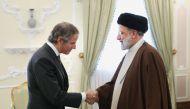A handout picture provided by the Iranian presidency shows Iran's President Ebrahim Raisi welcoming International Atomic Energy Agency (IAEA) chief Rafael Grossi ahead of their meeting in Tehran on March 4, 2023. (Photo by ATTA KENARE / Iranian Presidency / AFP)
