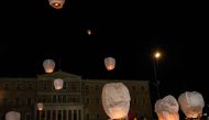 Supporters of the Greek Communist party release lanterns in front of the parliament during a protest following the deadly train accident near the city of Larissa, where 57 people, mainly students lost their live, in Athens on March 4, 2023. Photo by Angelos Tzortzinis / AFP