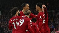 Liverpool's Dutch striker Cody Gakpo (second right) celebrates with teammates after scoring the opening goal of the English Premier League match between Liverpool and Manchester United at Anfield in Liverpool, north west England on March 5, 2023. (Photo by Paul ELLIS / AFP)