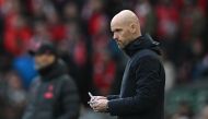 Manchester United's Dutch manager Erik ten Hag makes notes during the English Premier League match between Liverpool and Manchester United at Anfield in Liverpool, north west England on March 5, 2023. (Photo by Paul ELLIS / AFP)