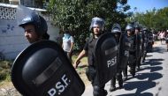 Police arrive at the site where people loot and destroy the house of an alleged drug trafficker in Rosario, Santa Fe province, Argentina, on March 6, 2023, in protests over the killing of a child in the middle of a shooting while playing in the street last Saturday night. (Photo by STRINGER / AFP)