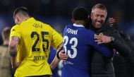 Dortmund's German defender Niklas Sule (L) reacts as Chelsea's English head coach Graham Potter (R) celebrates with Chelsea's French defender Wesley Fofana after the UEFA Champions League round of 16 second-leg football match between Chelsea and Borrusia Dortmund at Stamford Bridge in London on March 7, 2023. - Chelsea won the match 2-0. (Photo by Adrian DENNIS / AFP)
 