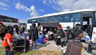 Migrants arrive at Tunis-Carthage International airport on March 7, 2023 as they prepare to leave Tunis on a repatriation flight.  (Photo by FETHI BELAID / AFP)