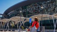 A passenger walks at Arturo Merino Benitez International Airport in Santiago on March 8, 2023, after an attempted robbery of more than 32 million US dollars from an armoured van which had just picked the money from a Latam Airline plane arriving from Miami.   (Photo by Karin POZO / AFP)